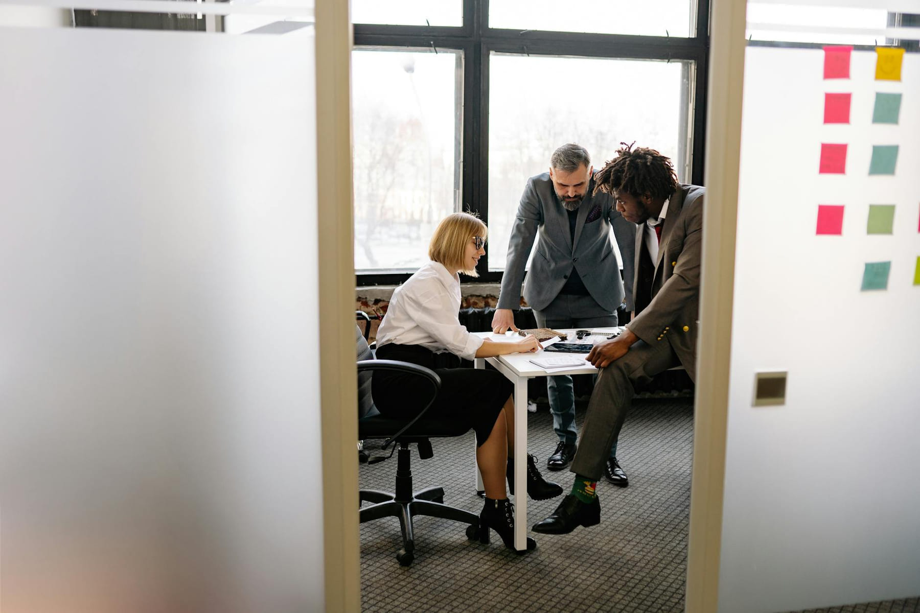 Diverse team engaged in a collaborative meeting in a modern office environment. on Small Biz Blueprint