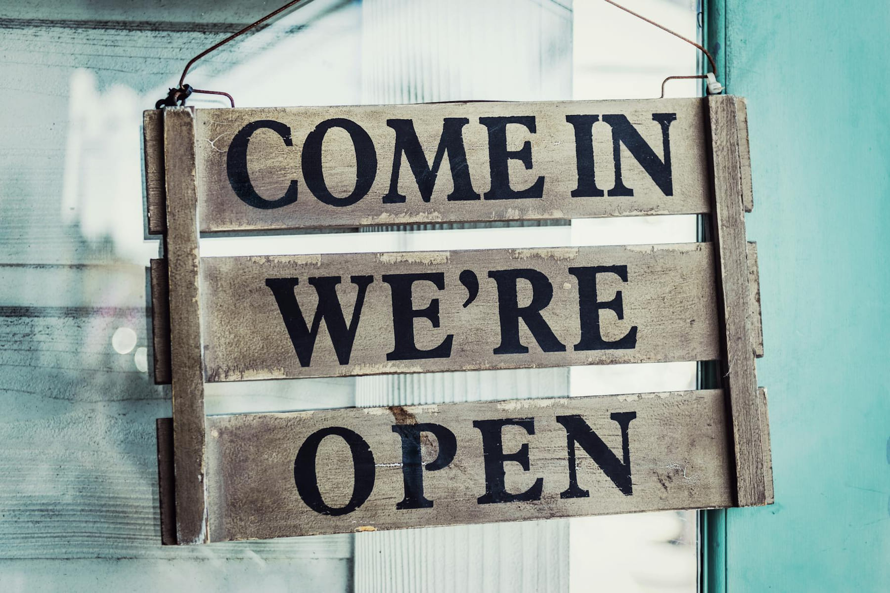 Close-up of a rustic open sign welcoming customers. Perfect for business or commerce themes. on Small Biz Blueprint