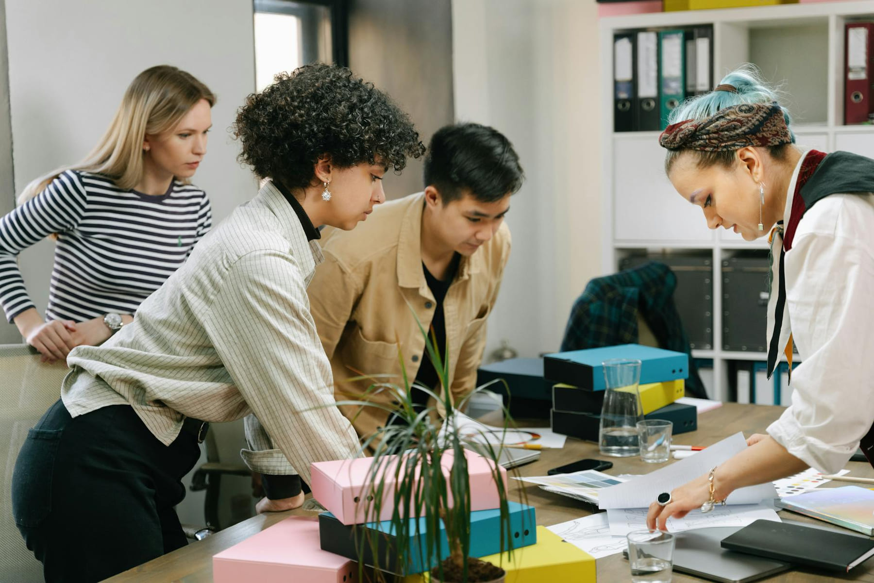 A diverse team of colleagues collaborating on a business project in a modern office setting. on Small Biz Blueprint