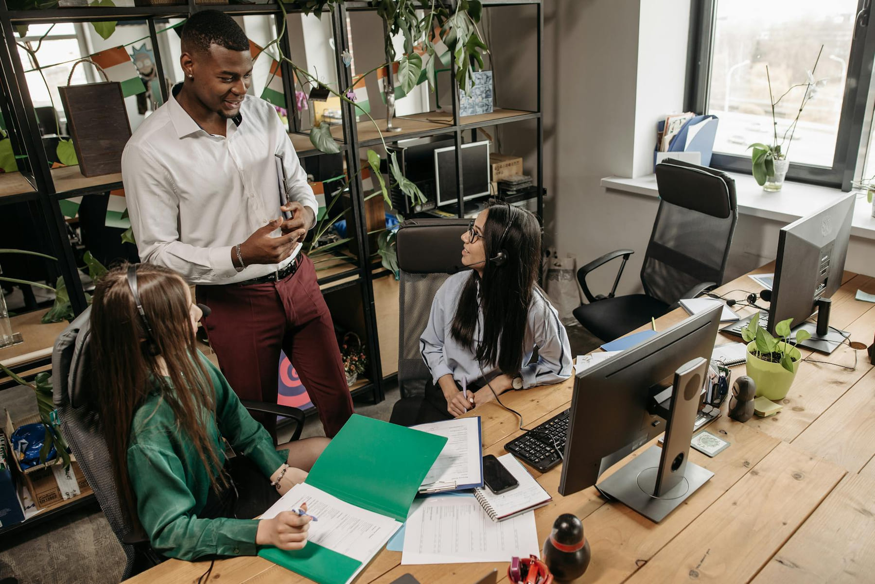 A team of diverse workers collaborating in a modern office setting. on Small Biz Blueprint